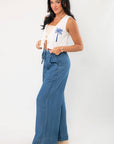 Side view of Versatile Dark Wash Denim Wide Leg Drawstring Pants highlighting the flowy wide leg cut and high-rise elastic waistband.