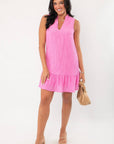 Model wearing THML Pink Textured Sleeveless Dress with nude heels and handbag, showcasing a chic look for weddings or vacations.