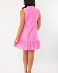 Back view of THML Pink Textured Sleeveless Dress showing ruffled hem and vertical texture, ideal for vacation or wedding guest attire.