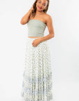 Free People Ivory Combo One Brynn Printed Maxi Skirt styled with a sage green tube top, showcasing boho chic elegance with tiered ruffles.