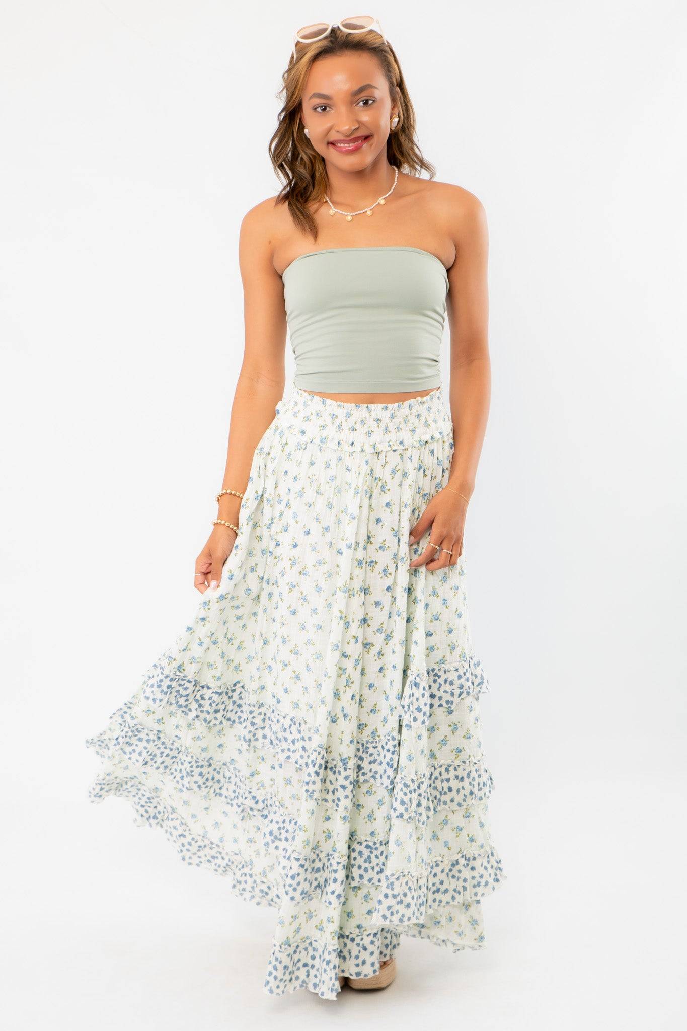 Model twirling in Free People Ivory Combo One Brynn Printed Maxi Skirt, highlighting its lightweight fabric and boho chic floral design.