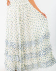 Close-up of Free People Ivory Combo One Brynn Printed Maxi Skirt featuring delicate floral prints and flowy tiered ruffles for a coastal cowgirl vibe.