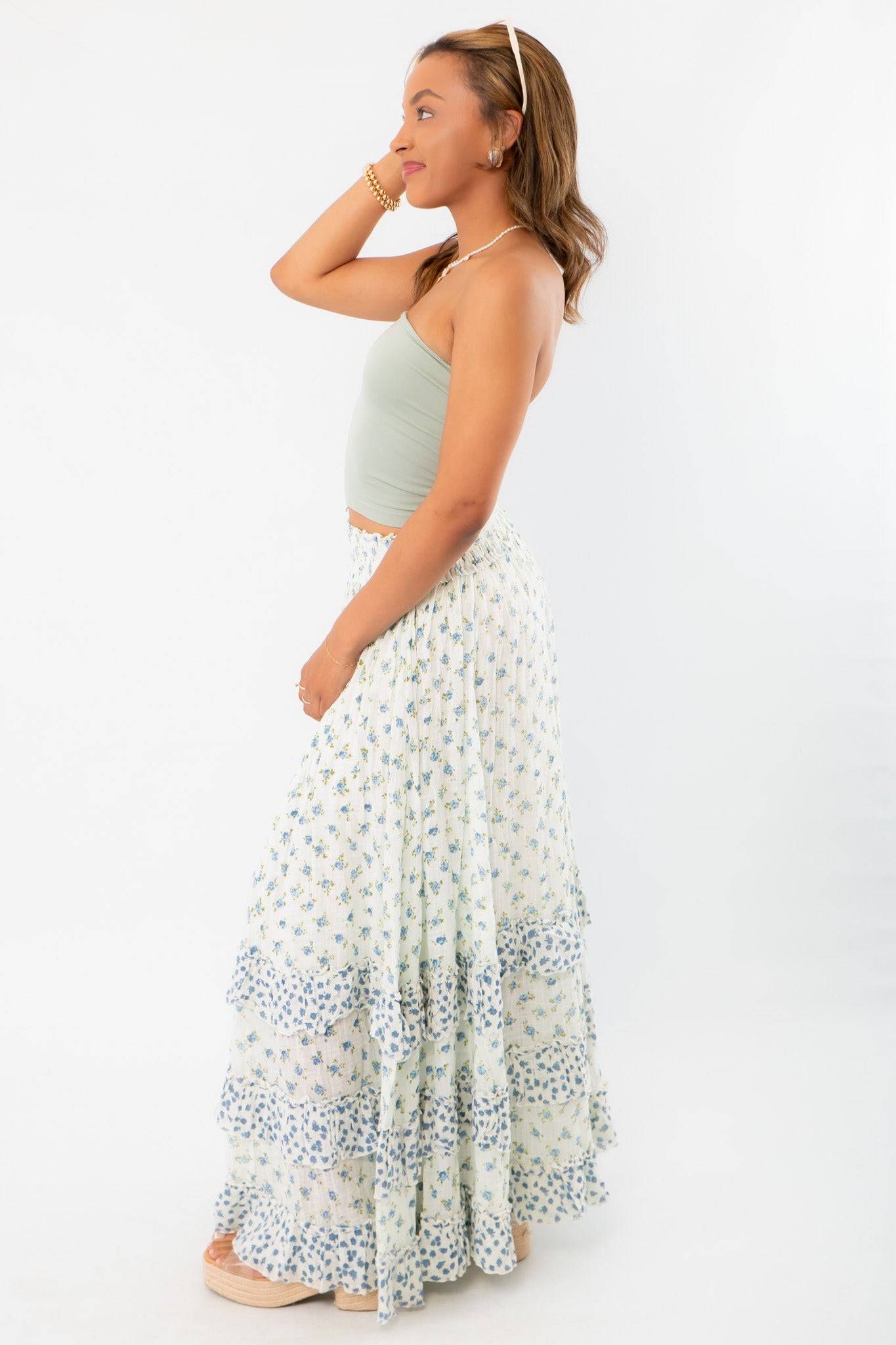 Side view of Free People Ivory Combo One Brynn Printed Maxi Skirt, emphasizing the flowy silhouette and soft floral pattern for beach-ready style.