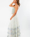 Side view of Free People Ivory Combo One Brynn Printed Maxi Skirt, emphasizing the flowy silhouette and soft floral pattern for beach-ready style.