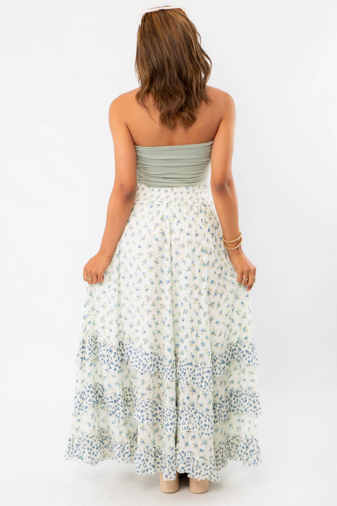 Back view of Free People Ivory Combo One Brynn Printed Maxi Skirt, showcasing the tiered ruffle details and breezy boho chic aesthetic.