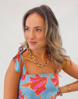 Detail view of THML Tie Strap Flower Print Maxi Dress highlighting shoulder tie straps and bold floral print, great for summer getaways.