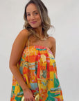 Colorful Show Me Your Mumu Postcards From Italia Bubble Dress styled with a gold chain bag, ideal for parties or summer date nights.