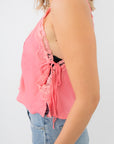 Side view of Free People Conch Shell Pink Someone Like You Cami highlighting ribbon tie and split hem for a feminine silhouette.