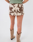 Back view of Sierra Rodeo Cow Print Mini Skort with zipper closure and bold cow print design, perfect for fairs, rodeos, and weekend outings.