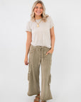 Smokey Sage Cactus Blossom studded wide leg pants styled casually with a striped tee, showcasing relaxed fit and boho-chic versatility.