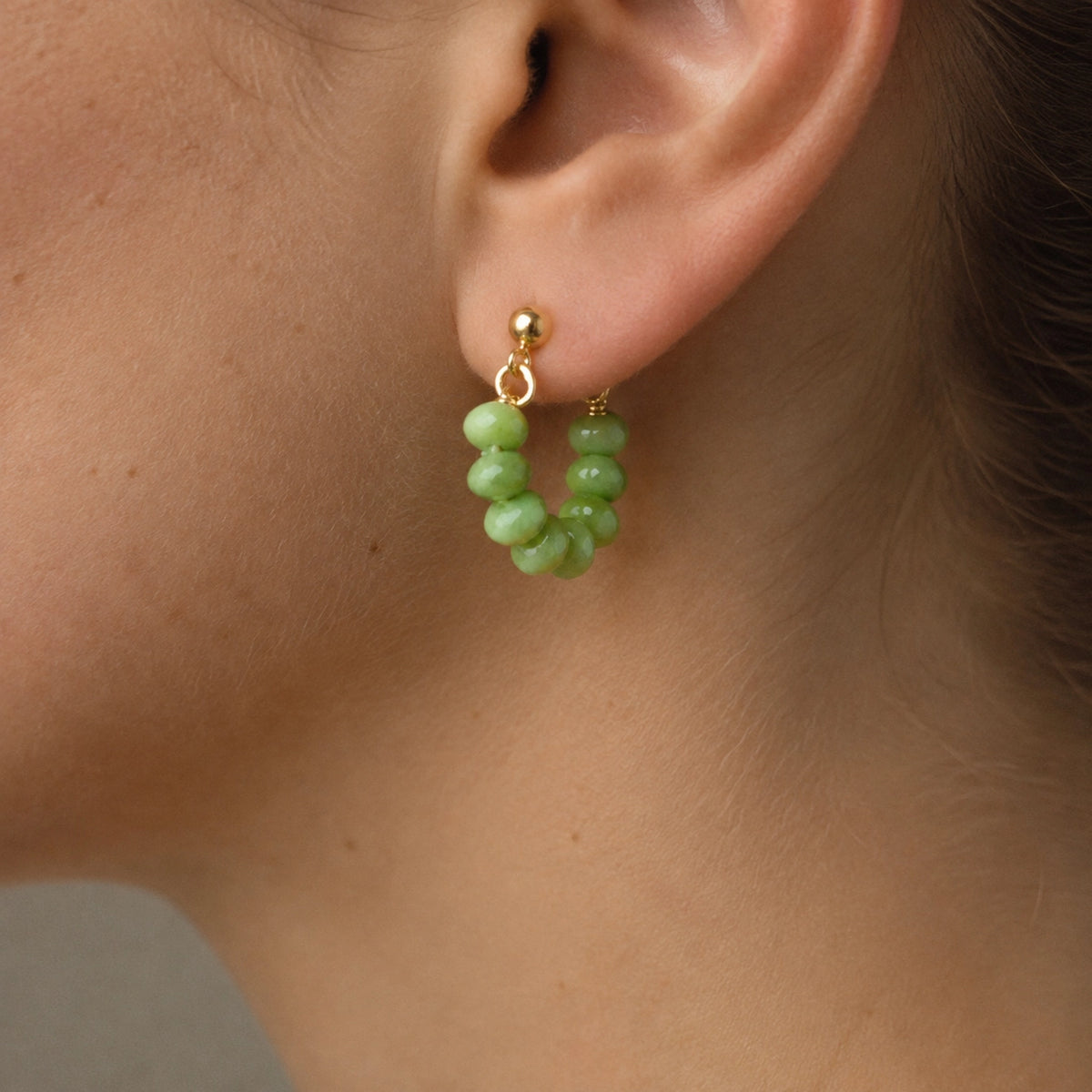 Lightweight fall statement green earrings
Gold stud loop earrings with green beads