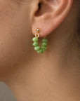 Lightweight fall statement green earrings
Gold stud loop earrings with green beads
