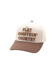 Play Something Country Trucker Hat by Rustler Hat Co. featuring bold brown embroidered text on a cream front panel with a brown bill.