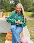 Pumpkin Pie Cutie Hunter Green Pullover Sweatshirt styled for fall with jeans and boots, perfect for cozy outdoor gatherings.