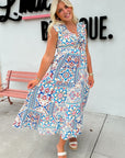 Woman wearing a colorful patterned dress standing in front of a store sign.