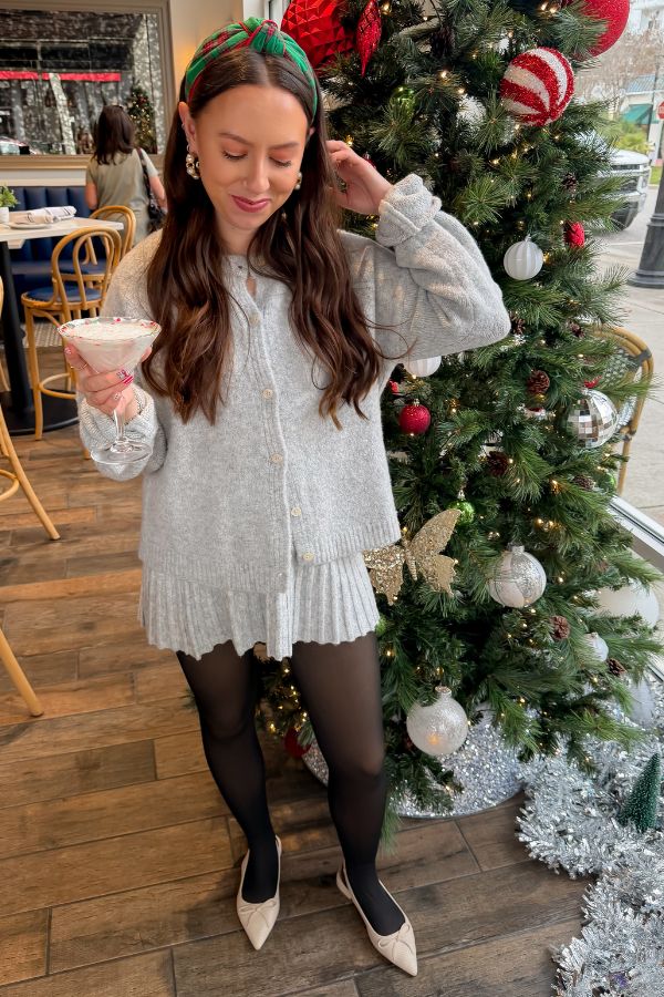 Livia Grey Button Up Sweater Skirt Set styled for the holidays with black tights and flats, perfect for festive winter gatherings.