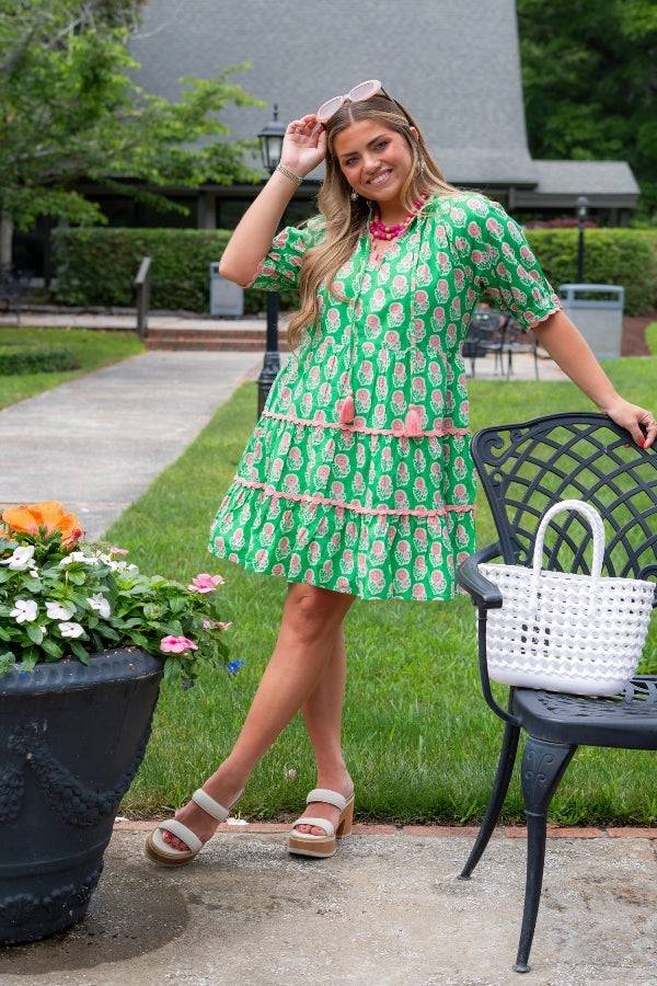 THML Green Floral Puff Sleeve Dress with pink floral print and tiered skirt, styled for summer glamour in a garden setting.