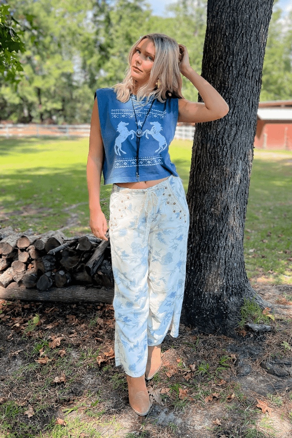 Trail Blazer Blue Tank Top styled with floral lace-up pants and boots, perfect for fall country concerts or casual outings.