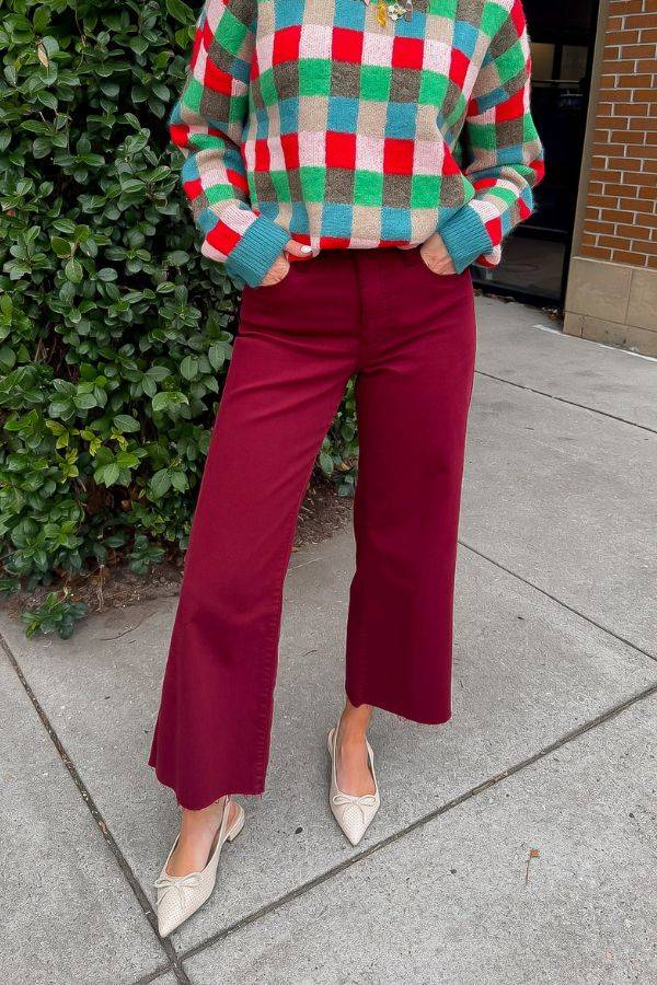 Kut Maroon Meg High Rise Jeans styled with a festive checkered sweater and pointed flats. Wide leg cut perfect for holiday outfits.