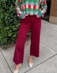 Kut Maroon Meg High Rise Jeans styled with a festive checkered sweater and pointed flats. Wide leg cut perfect for holiday outfits.