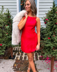 Noelle Red Bow Square Neck Mini Dress styled for the holidays with faux fur shawl, ideal festive outfit for Christmas parties and winter events.