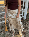 Old West Satin Maxi Skirt styled with a ribbed top and woven handbag, highlighting the flowy satin fabric and western-themed print in a fall setting.