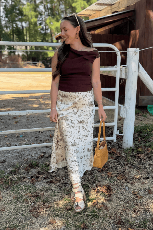 Friday Feeling Brown Asymmetrical Top worn with printed maxi skirt, ideal for stylish fall outfits and seasonal layering.