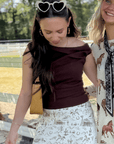 Friday Feeling Brown Asymmetrical Top styled with western print skirt, perfect for fall fashion and outdoor gatherings.
