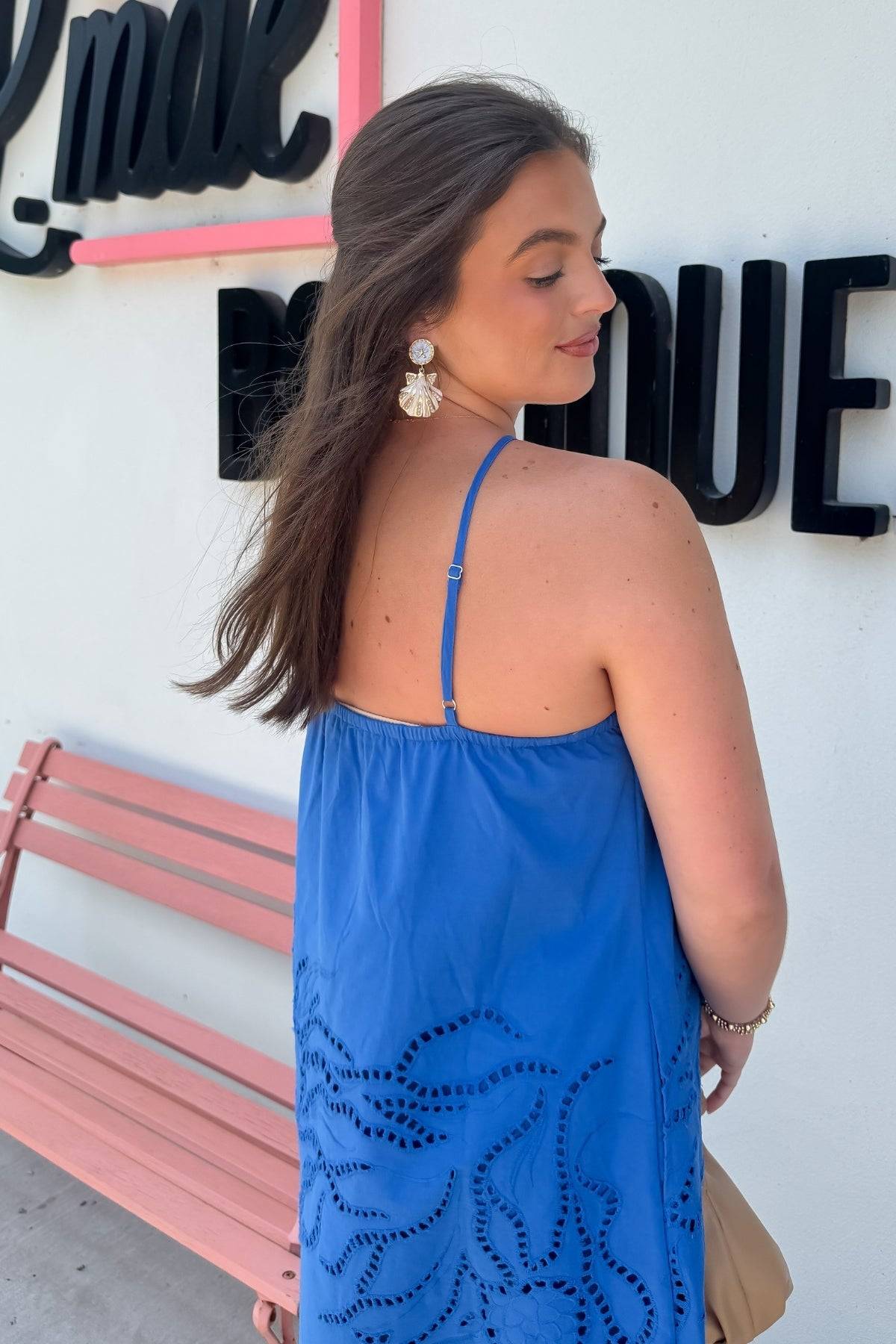 Detail of back design on MINKPINK Royal Blue Darla Broderie Mini Dress with adjustable straps and floral embroidery for a breezy summer look.
