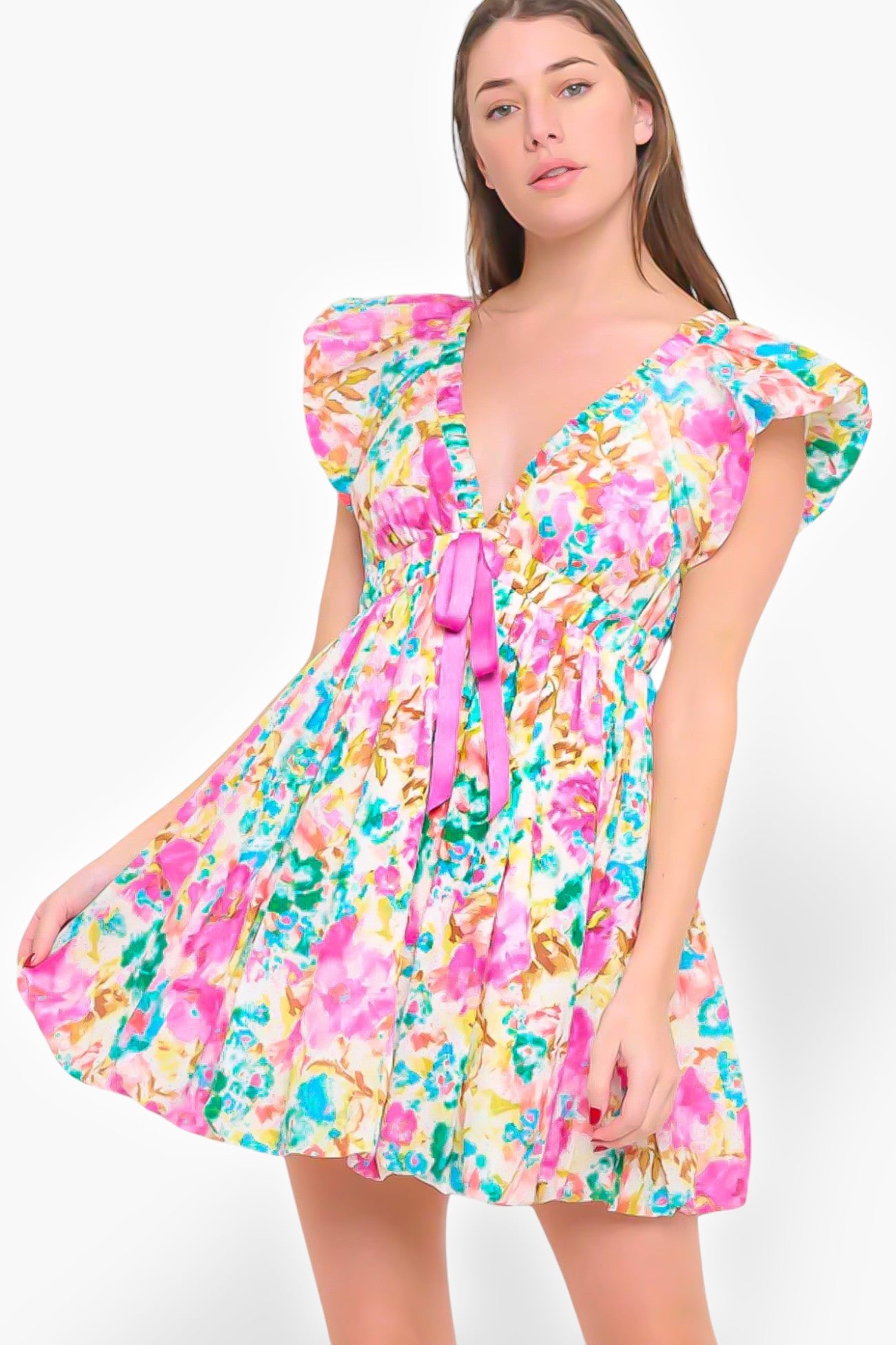 Floral Meet Me in Santorini Aegean Garden Dress featuring a deep V-neck, flutter sleeves, and a pink ribbon tie. Perfect for spring and summer occasions.