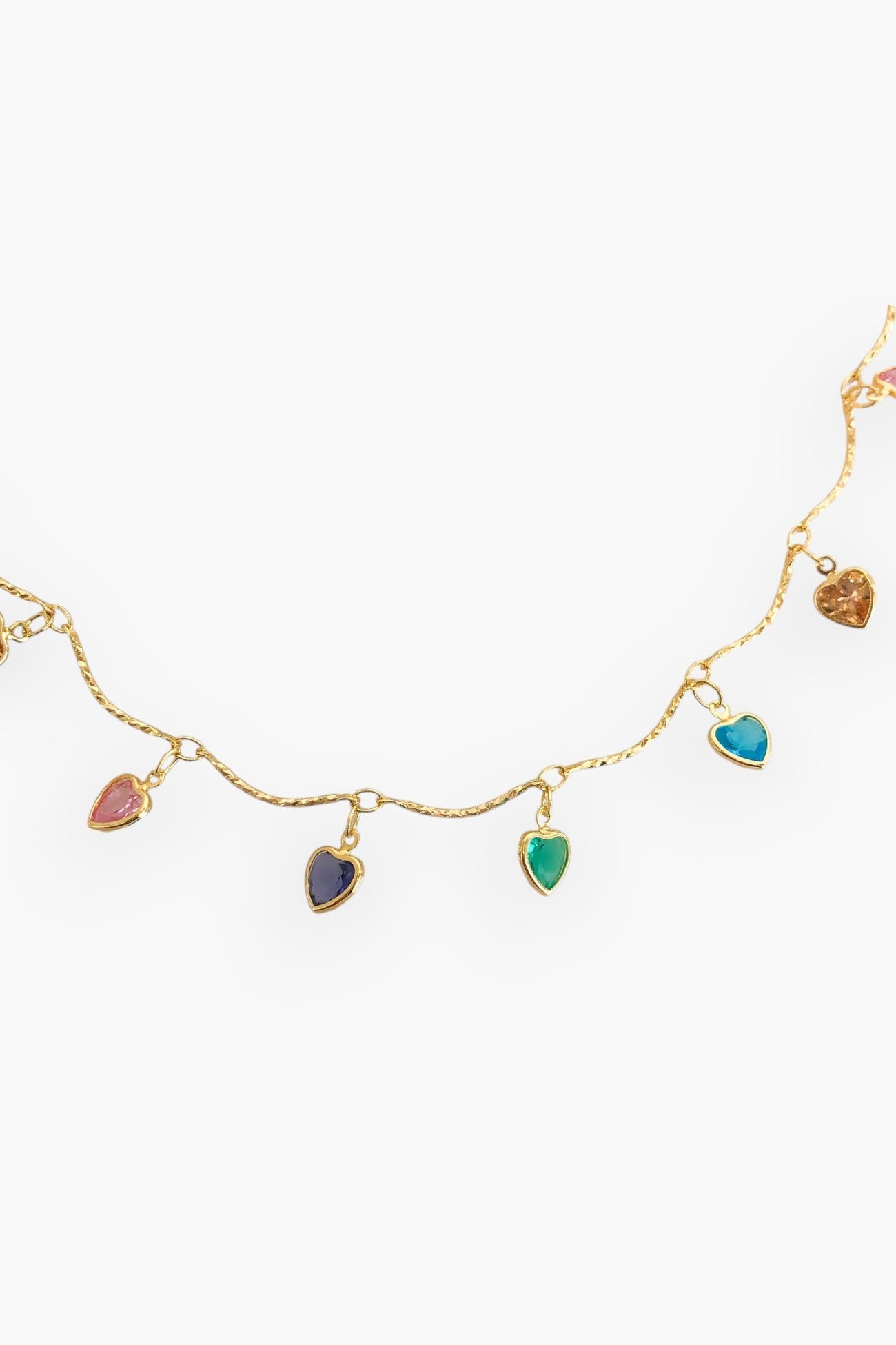 Close-up of the All Mine Colorful Heart Charm Necklace showcasing multicolor heart-shaped cubic zirconia charms on a delicate gold-plated chain.