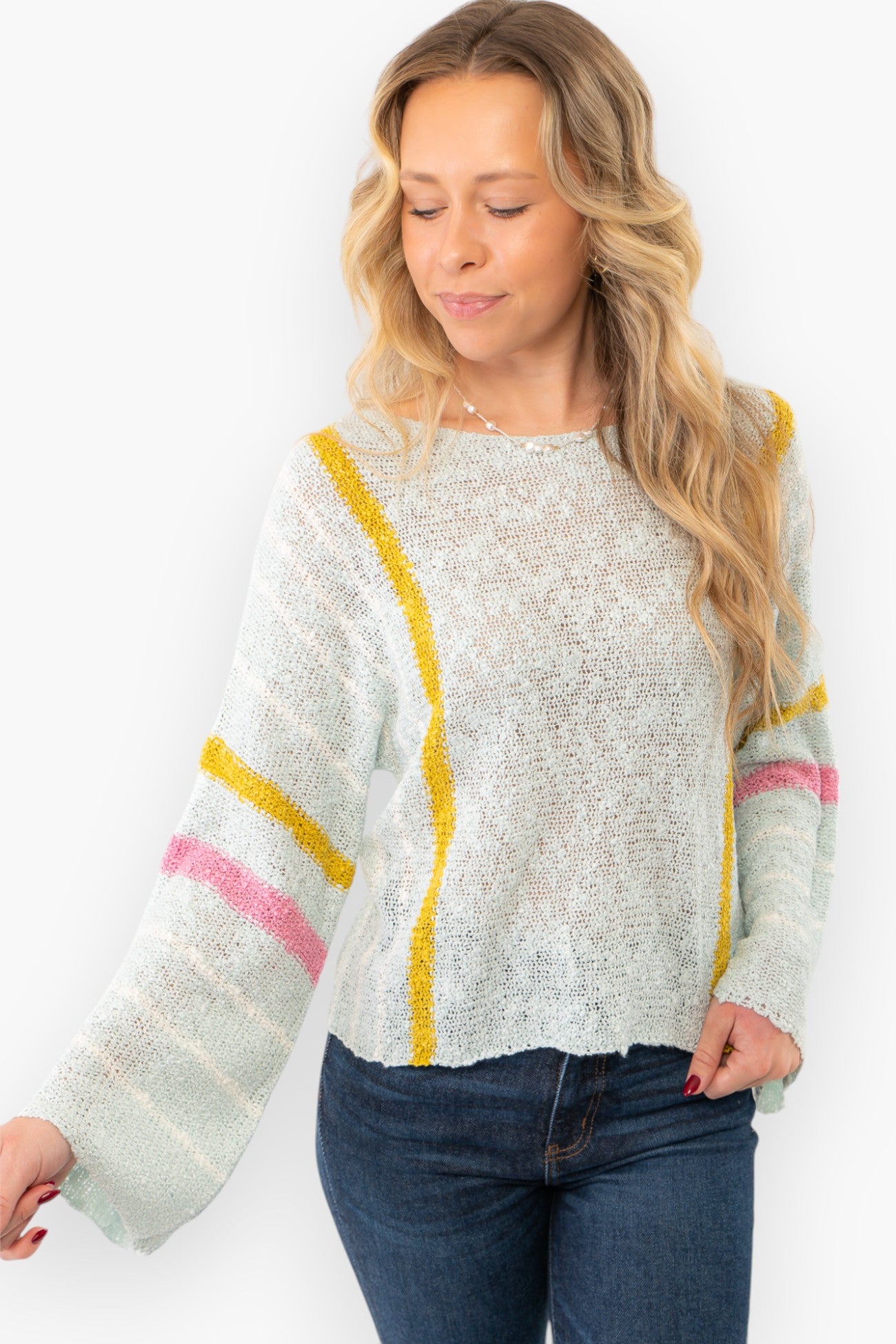 Close-up of Baha Mint Stripe Beach Sweater with bell sleeves and pastel stripes. A lightweight and breathable knit sweater for effortless style.