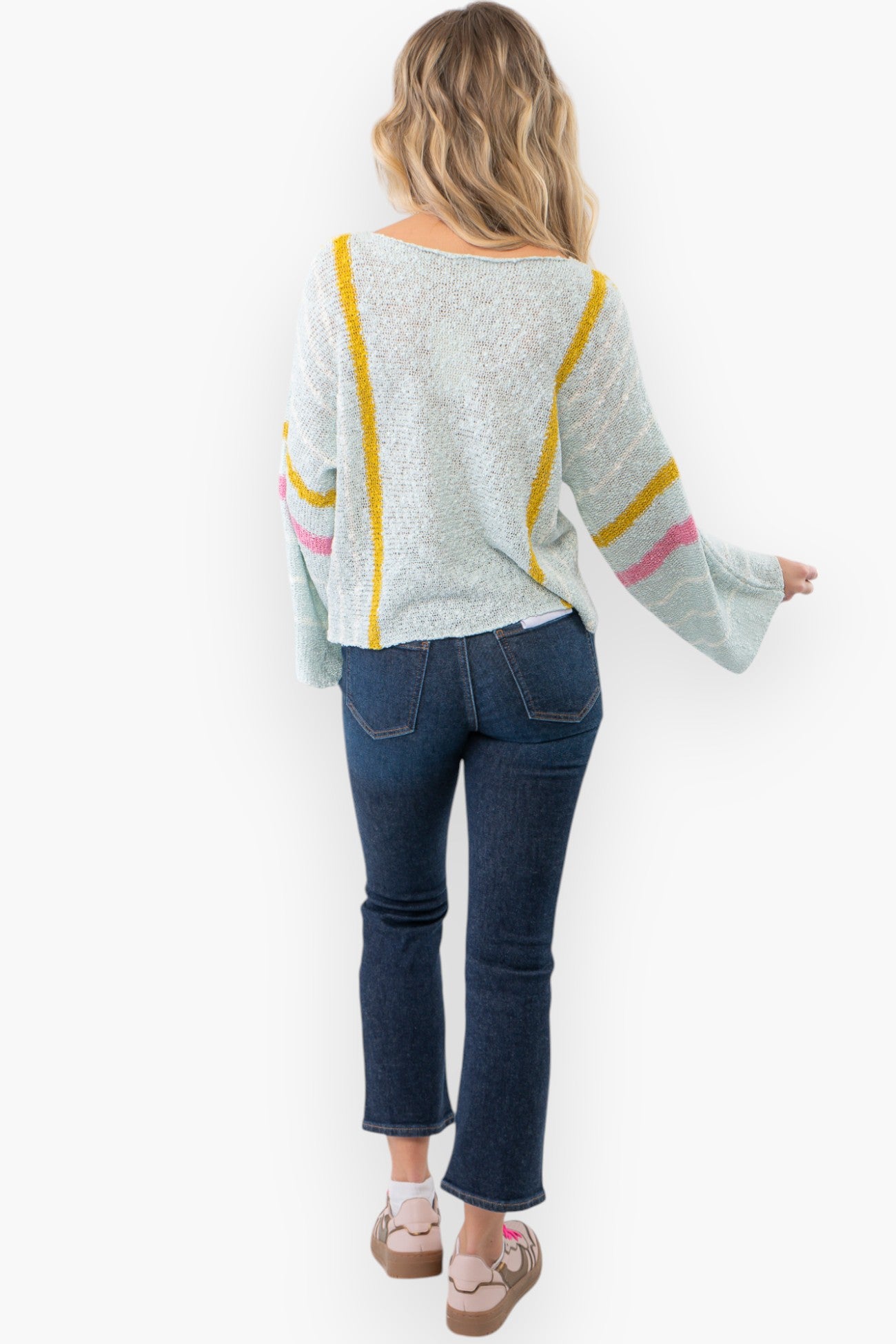 Back view of Baha Mint Stripe Beach Sweater highlighting its airy knit fabric and pastel stripe design. A perfect layering piece for beach vacations.