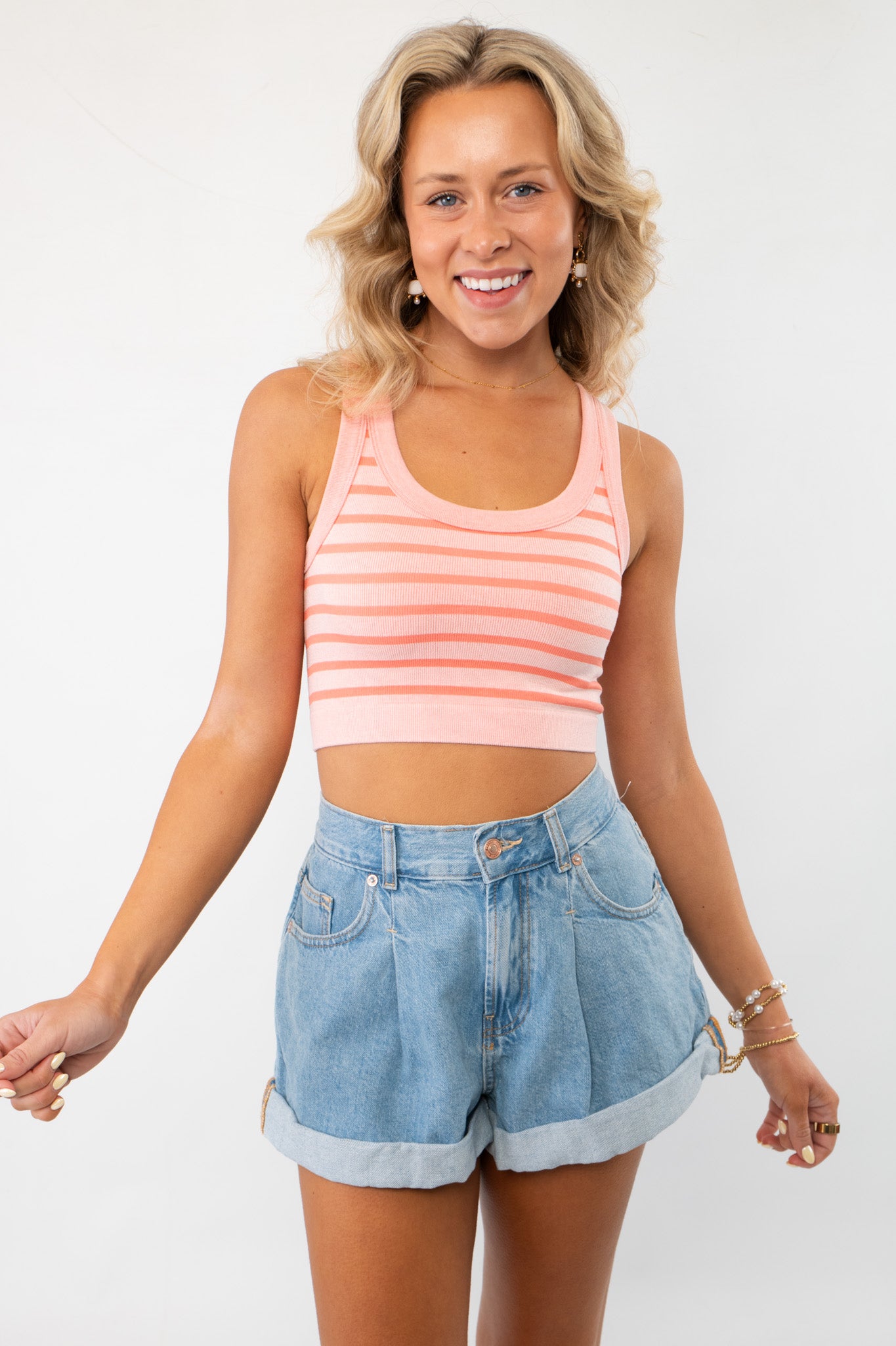 Better in Stripes Pink Brami - a stylish pink striped cropped tank top, perfect for summer outfits. Features a scoop neckline and ribbed texture.