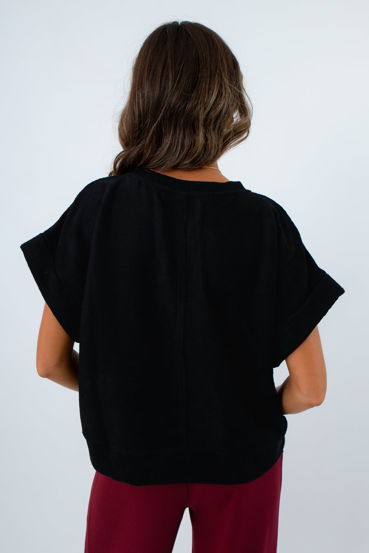 Comfortable brushed knit top with short sleeves for transitional seasons, elevated basic black knit top for fall