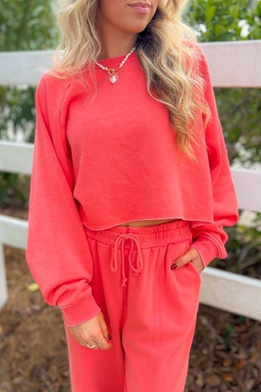 Coral Feeling Long Sleeve Crop Sweatshirt with a raw hem and relaxed fit, paired with matching sweatpants for a stylish and comfortable lounge look.