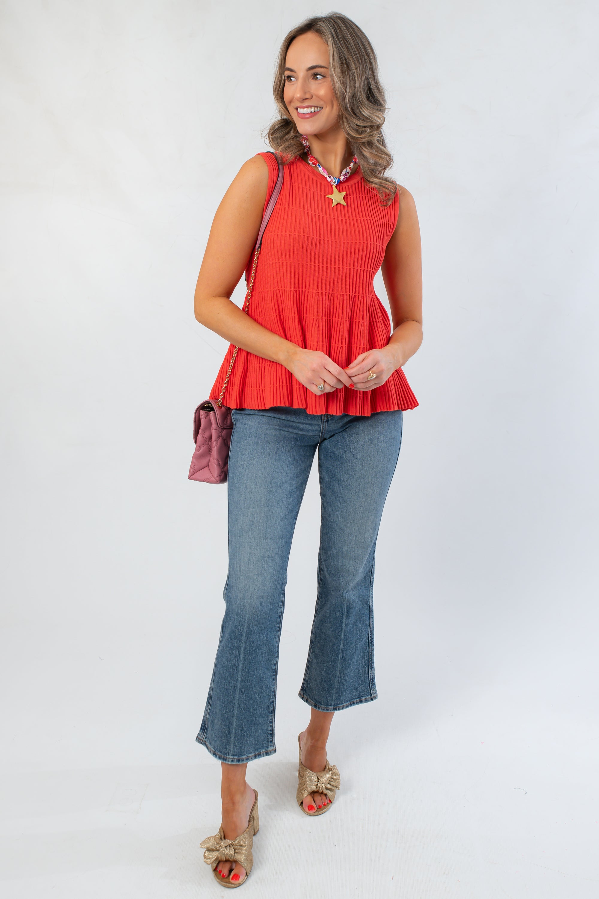 Papaya Flared Rib Knit Top styled with jeans and heels, featuring a sleeveless peplum silhouette and textured ribbed fabric for a chic fall look.