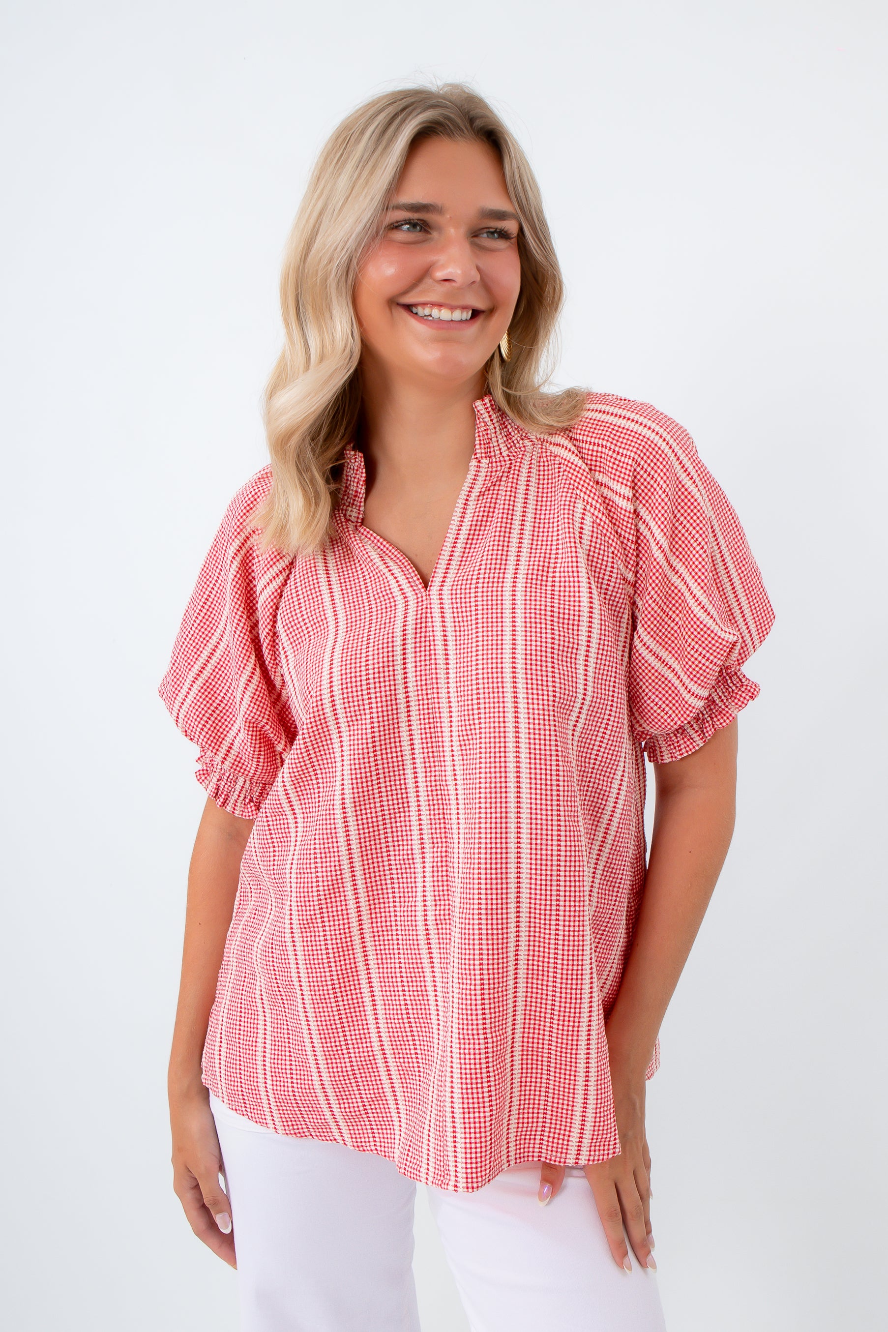Woman wearing a red and white striped blouse styled for a summer picnic 