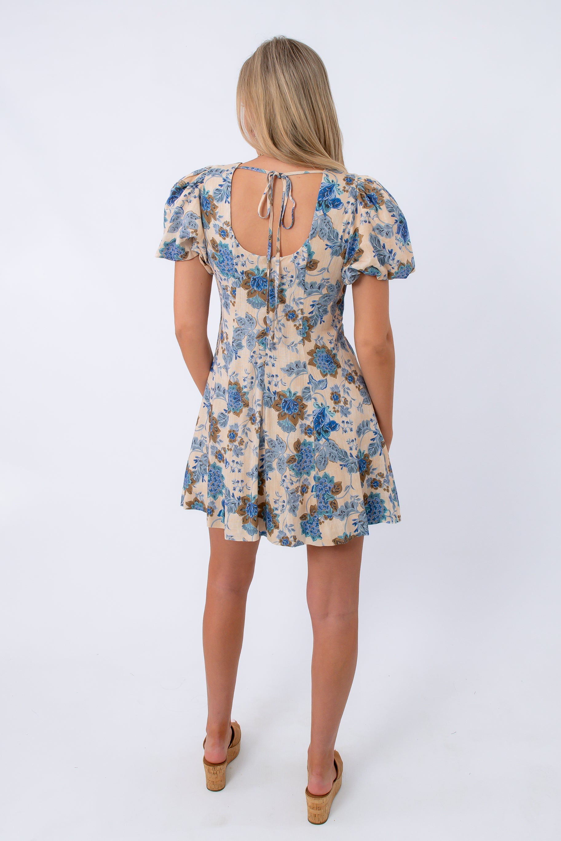 Floral mini dress with puff sleeves and back tie, beige and blue pattern, stylish women's apparel