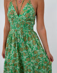 Green and pink floral maxi dress with halter neckline, perfect for wedding guests and summer occasions