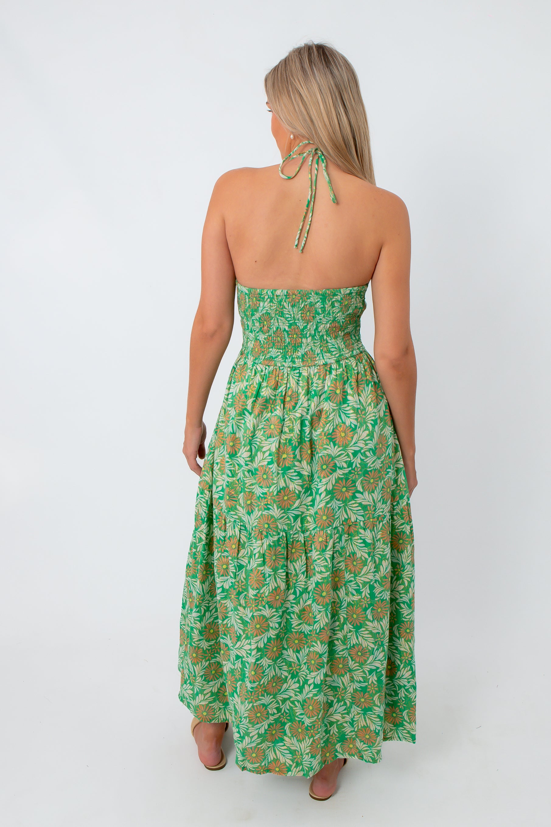 Back view of green and pink floral maxi dress with halter neckline