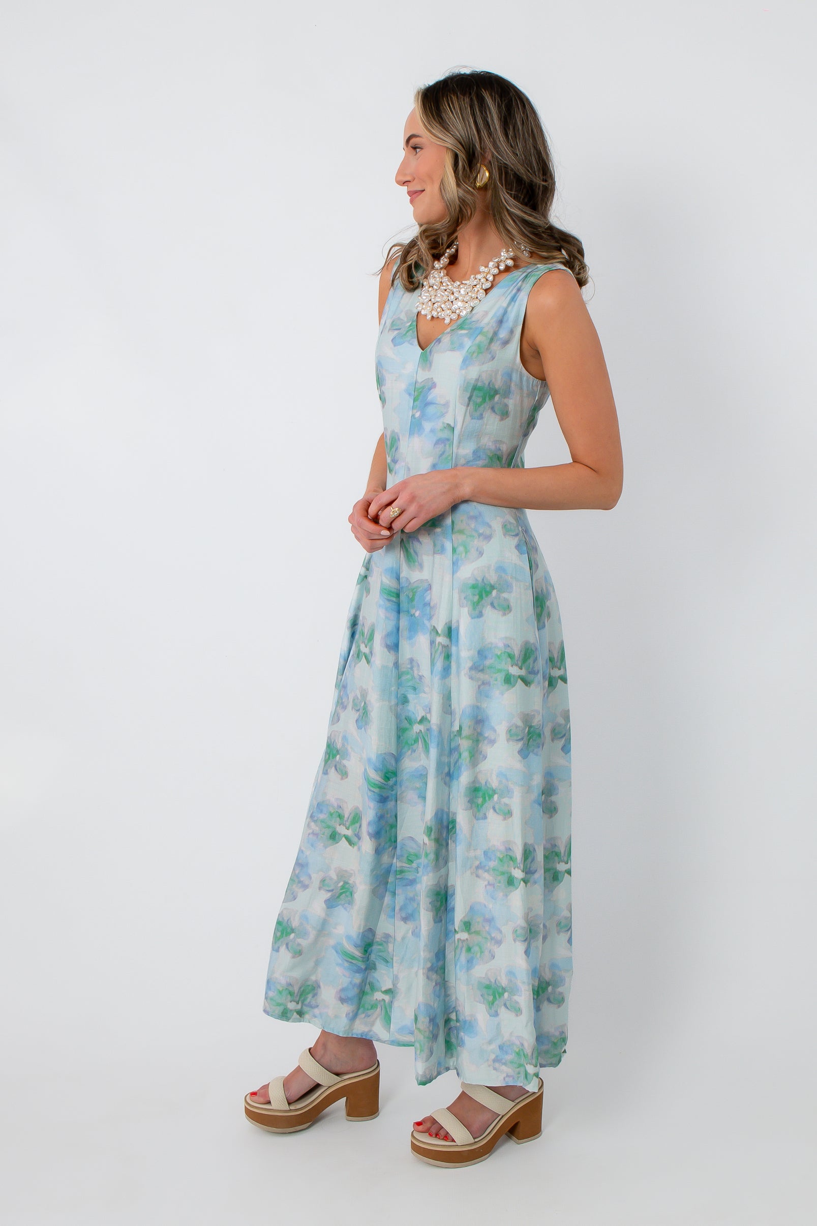 Side view of Watercolor Nymphéas Blue Floral Midi Dress with watercolor floral print, styled for spring events