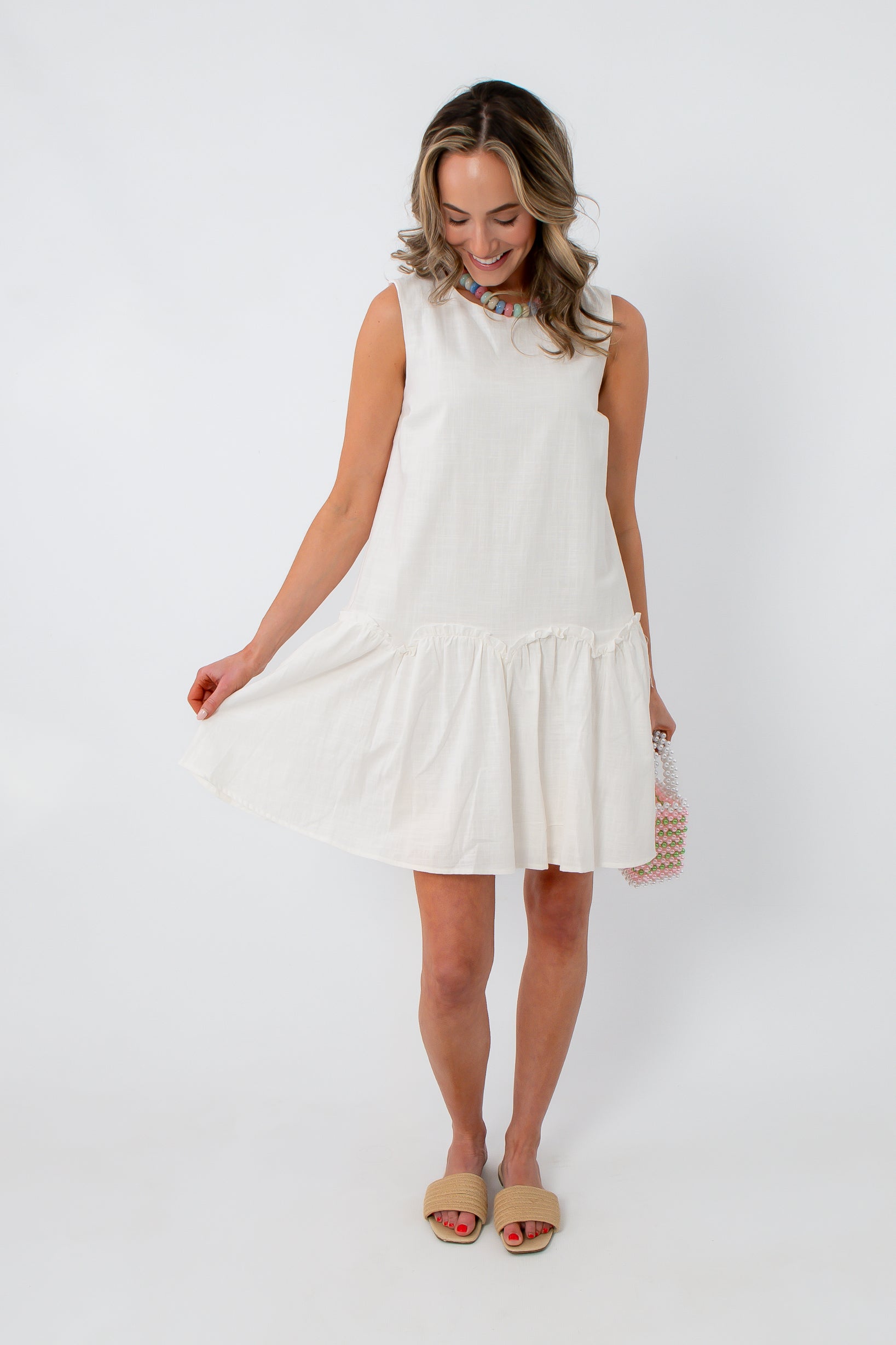 White cotton scallop hem mini dress with drop waist for spring and summer