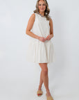 Front view of white scallop hem mini dress with sleeveless design and relaxed fit