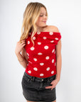 Asymmetrical off-shoulder style of Retro Romance Red Polka Dot Top with playful polka dots, ideal for date night or brunch styling.
