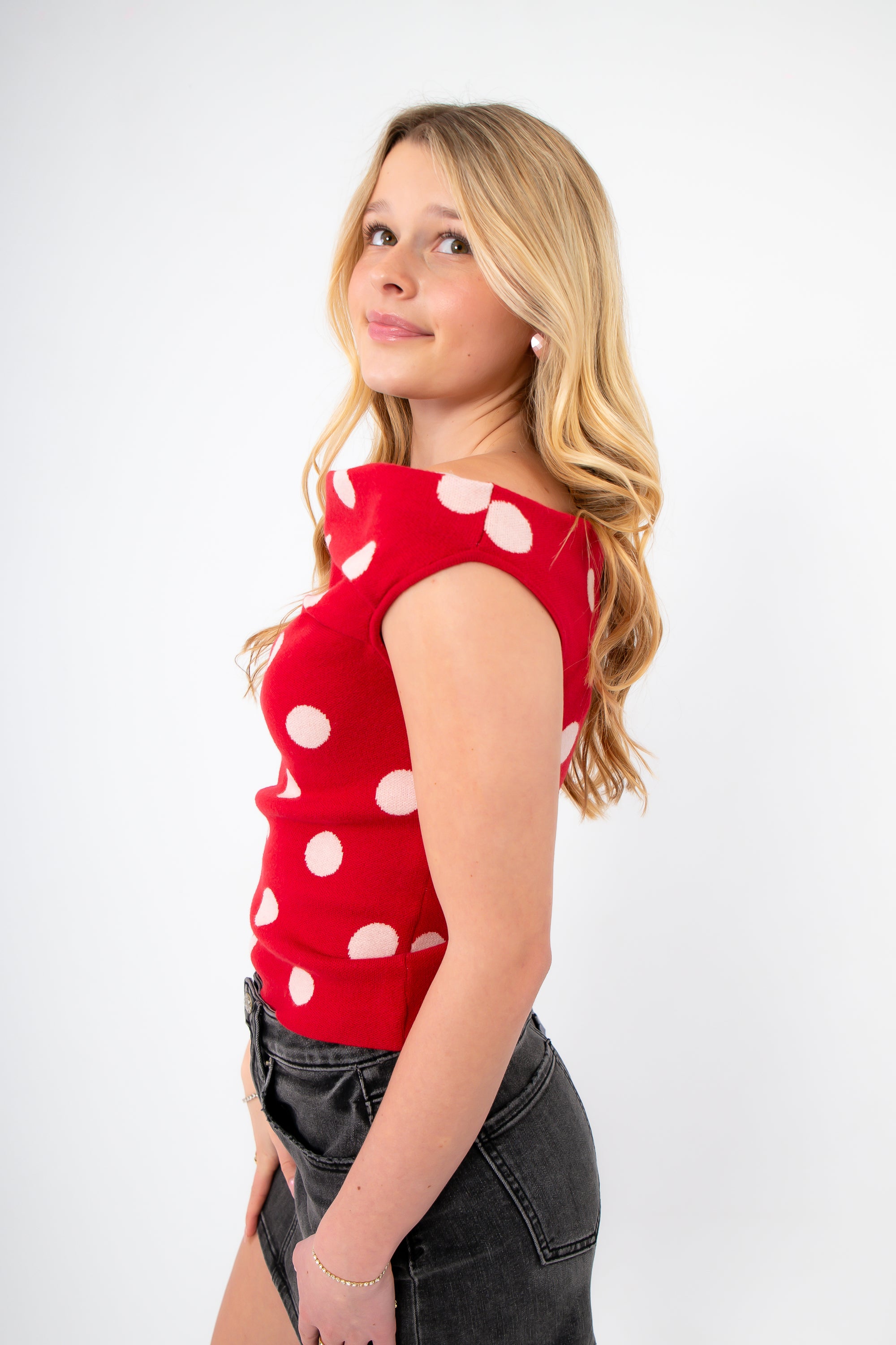 Side view of Retro Romance Red Polka Dot Asymmetrical Top showing cap sleeve and curve-hugging fit, perfect for Valentine's Day outfits.
