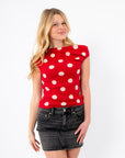Retro Romance Red Polka Dot Asymmetrical Top styled with a black denim mini skirt. Features bold white polka dots and a fitted silhouette.
