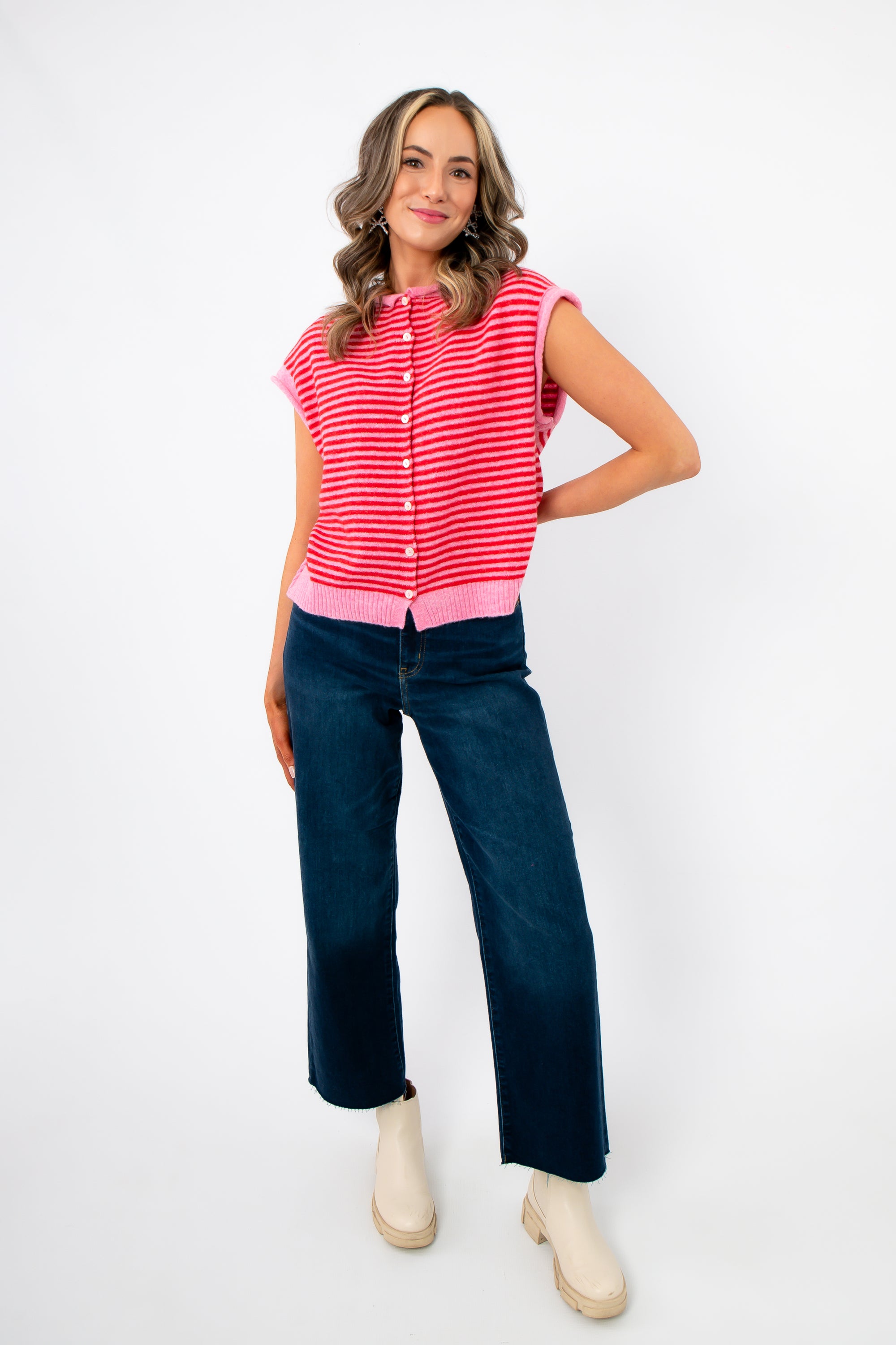 Model wearing Piper Pink Stripe Short Sleeve Cardigan paired with wide-leg jeans and boots, showcasing casual spring outfit styling.