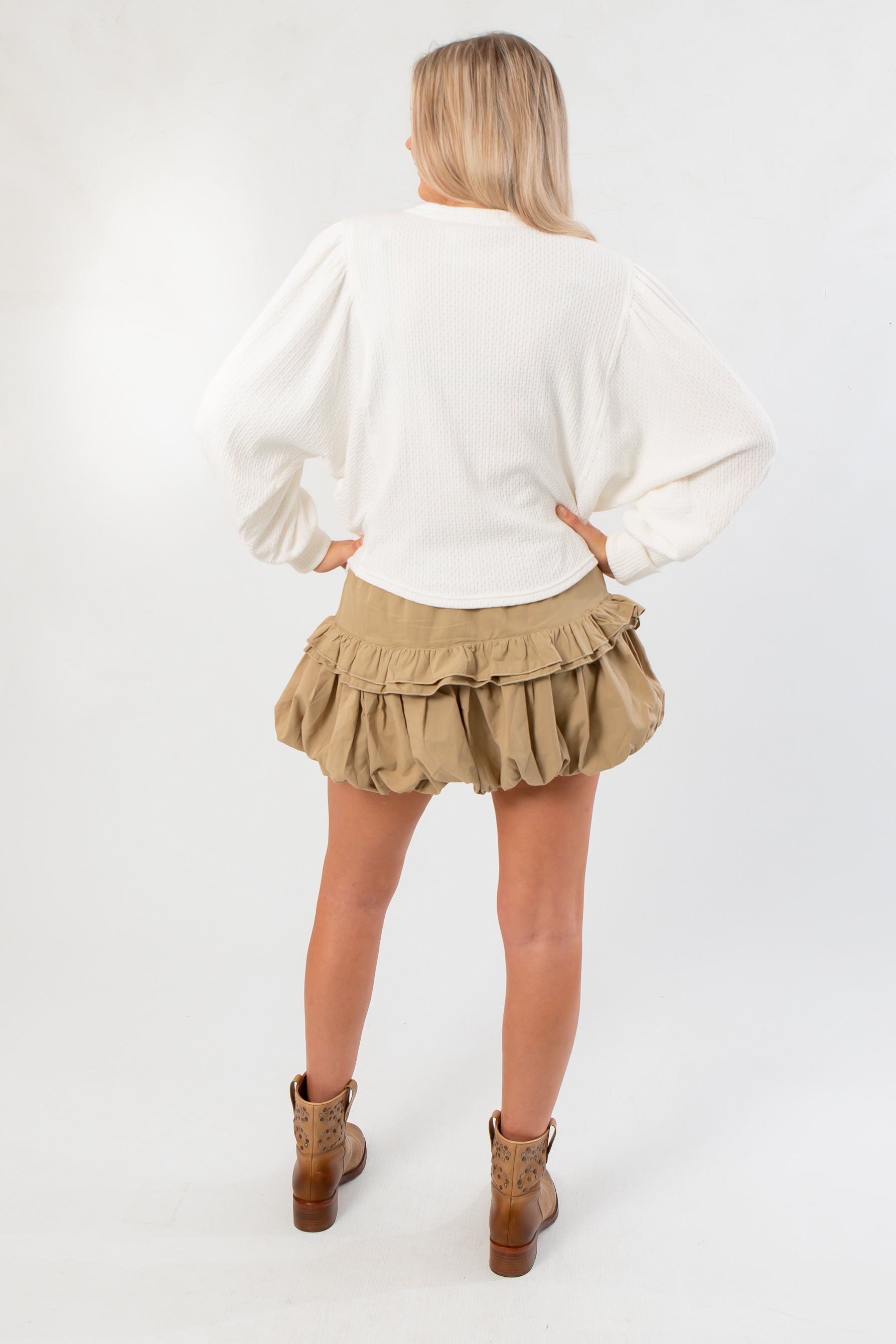 Back view of Free People Ivory Quinn Knit Top highlighting its loose silhouette and textured knit, perfect for casual layering.