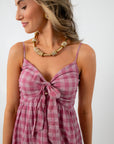 Model wearing pink gingham midi dress with platform sandals, styled for spring or summer events